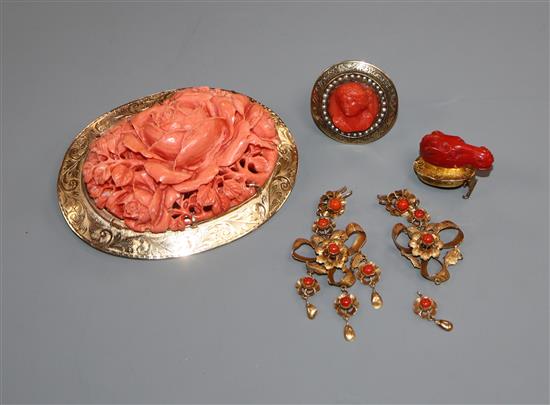 A large engraved yellow metal mounted carved coral oval brooch, an early 20th century 9ct, seed pearl and carved coral bust ring etc.